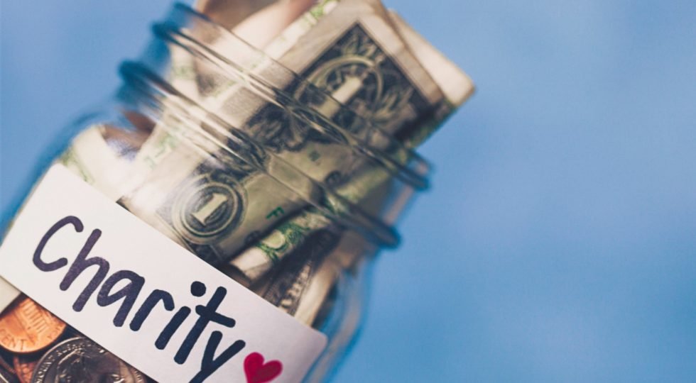 When donating cash may be less effective | jar of change marked for charity